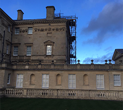 large traditional structure with a scaffolding network going up the side of it